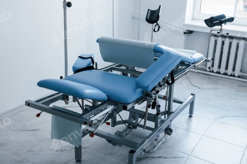 Preview: Blue colored obstetric bed indoors in the clinic cabinet at daytime