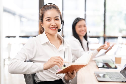 Preview: Beautiful asian businesswoman in call center consulting, speaking or talking at customer services.