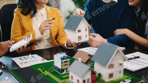 Real Estate Agents Showing House Models to Clients
