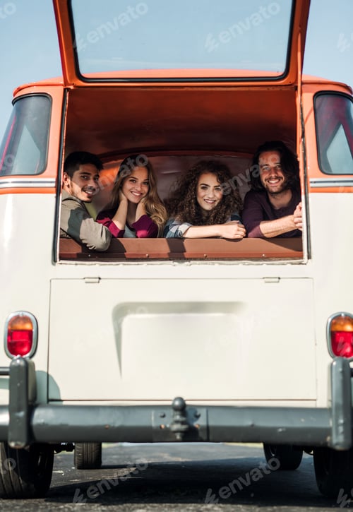 Preview: A group of young friends on a roadtrip through countryside, looking out of window.