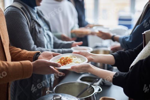 Preview: Volunteer Giving Meals to Refugees Standing in Line