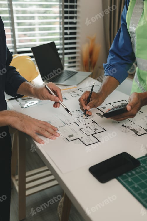 Preview: an engineer is in the office with his assistant, they are examining every detail in the blueprint, t