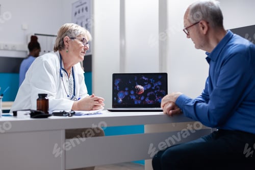 Preview: Doctor and patient discussing about illustration of coronavirus on laptop