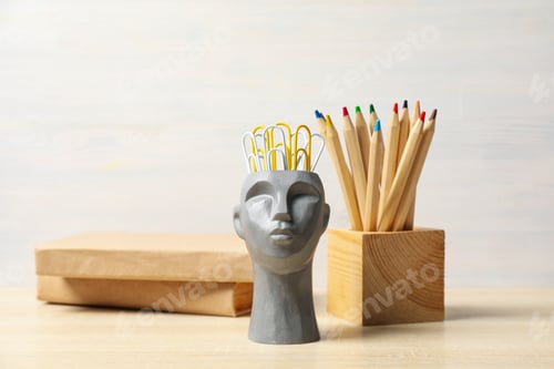 Preview: Drawing concept with decorative head on wooden table