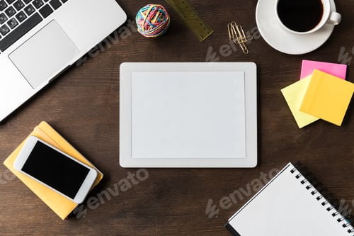 Preview: top view of tablet and other digital devices on home office table