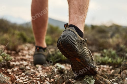 Preview: Cropped shot of an unidentifiable young hikers feet walking on a mountain trail
