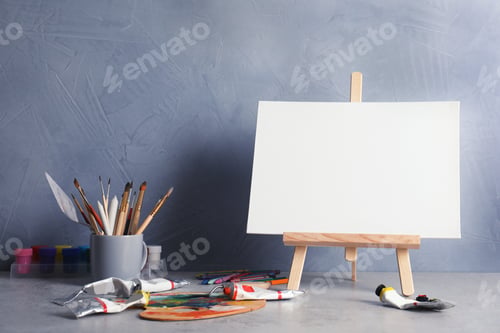 Preview: Blank Canvas on Easel with Painting Supplies