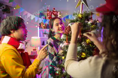 Preview: Adults and Teen Decorate Christmas Tree at Home