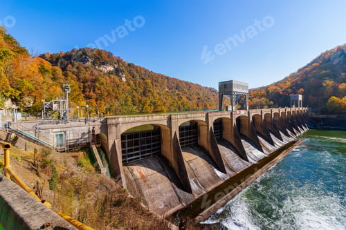 Preview: Majestic view of a dam spillway on the side of a mountain, with the tranquil waters of a lake below