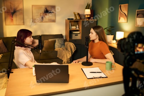 Preview: Two Caucasian Teen Girls Recording Podcast Conversation in Modern Studio Setting