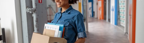 Preview: Happy female employer walking around the office with documents