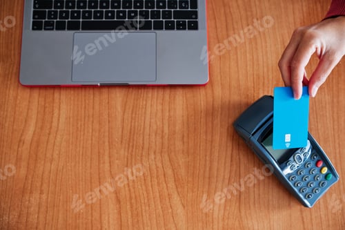Preview: woman's hand paying with credit card on contactless device