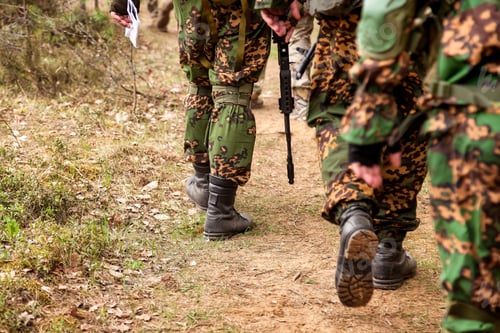 Preview: Rear view russian soldiers men gone on road military camouflage uniform with weapon in forest