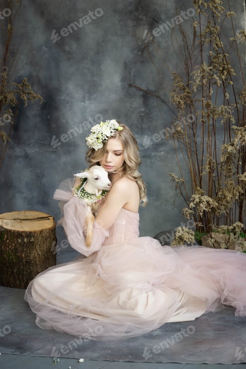Preview: A young blonde woman in an airy pink dress with a white kid. Spring portrait of a woman.