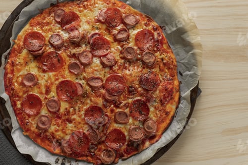 Preview: Overhead photography of a homemade pepperoni and sausage pizza
