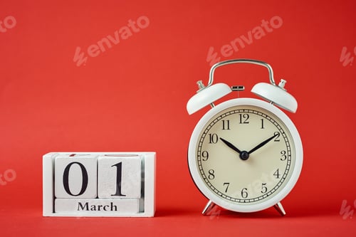 Preview: White retro alarm clock with bells and wooden calendar blocks with date 1 march