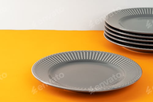 Preview: Glossy new ceramic dishware on paper background