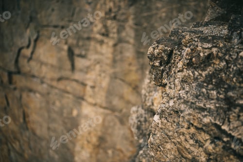 Preview: selective focus of surface of rocky cliff on blurred background