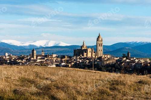 Preview: Segovia stunning skyline is framed by the snowy Guadarrama mountains in a picturesque landscape.