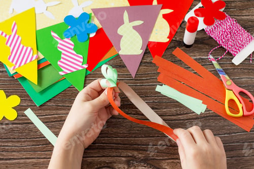 Preview: Festive Easter garland handmade with decoration of colorful rabbits and carrot.