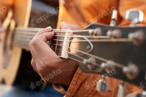 Preview: Close-up of hands strumming an acoustic guitar