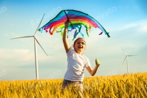Preview: Happy Little girl running in a wheat field with a kite in the summer.