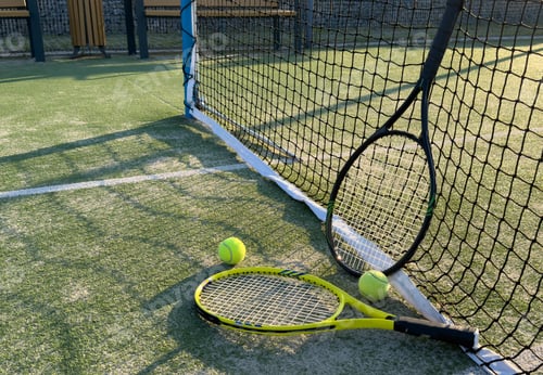 Preview: Close up of tennis balls on court by net
