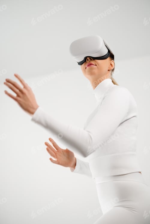Preview: Young Woman Using Virtual Reality Headset in Minimal Setting