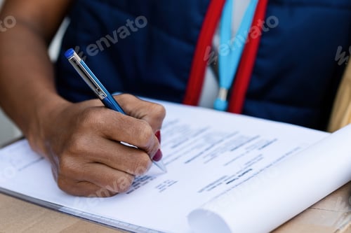 Preview: Close-up of delivery person filing paperwork.