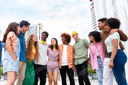Preview: Happy playful multiethnic group of young friends bonding outdoors