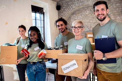 Preview: Portrait of volunteers with working in community charity donation center.
