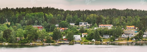 Preview: Sweden. Beautiful Swedish Wooden Log Cabins Houses On Rocky Island Coast In Summer Day. Lake Or