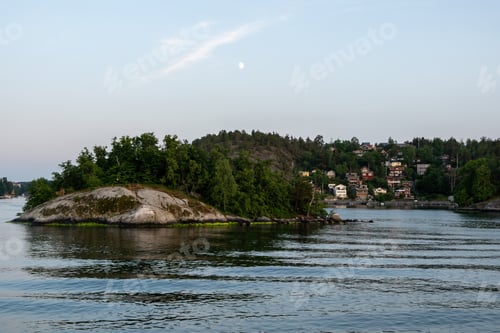 Preview: Archipelago Stockholm Sweden. Islet with lush nature in Baltic sea water, seaside villa, blue sky.