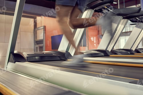 Preview: Running, fast and legs of a man on the treadmill for fitness, training and motivation in the gym. E