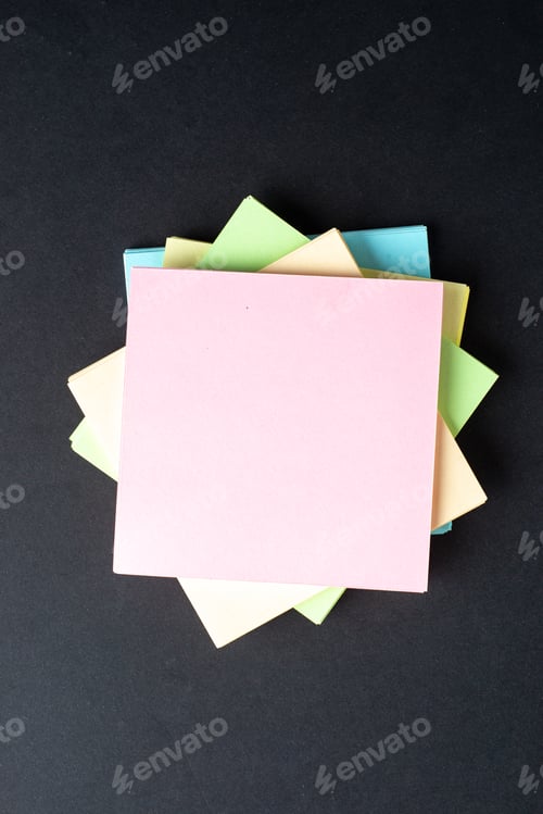 Preview: Vertical view of stacked sticky note cubes on isolated black wave background with free space