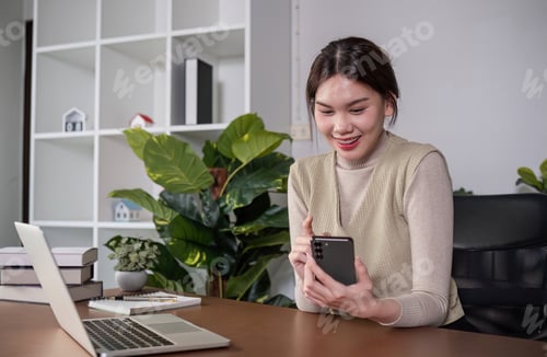 Preview: Asian college student sit at home studying online using a video calling program on their laptop.