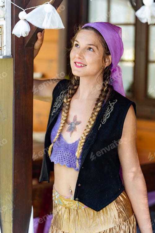 Preview: Young woman standing on the porch at home.