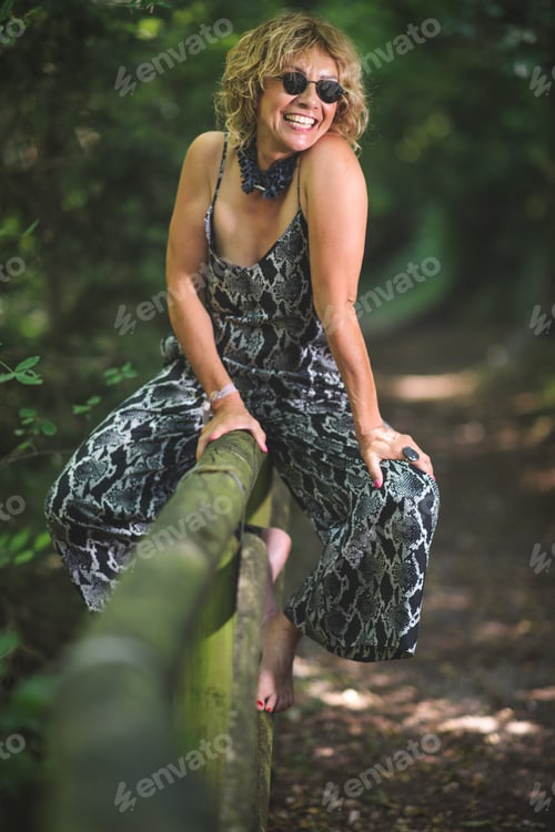 Preview: Youthful mature woman on fence