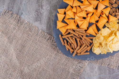 Preview: Variety of crispy crackers on wood piece