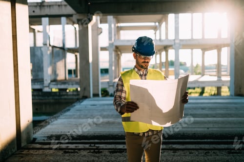 Preview: Picture of construction site engineer looking at plan