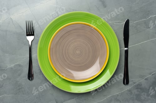 Preview: Color ceramic plates on gray background top view