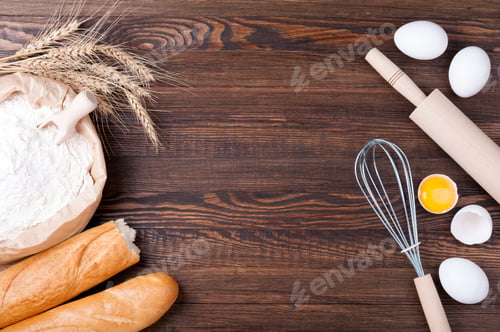 Preview: Flour in paper bag, wheat and baguette on wooden background. Ingredients for baking - flour, eggs