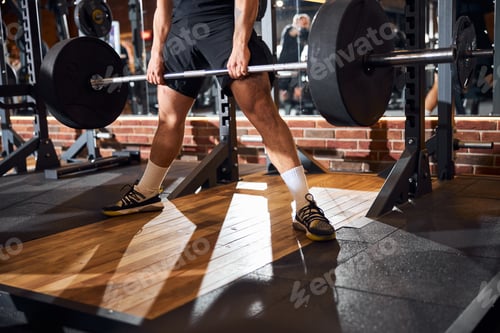 Preview: Male bodybuilder having a productive workout at the gym