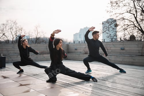 Preview: Three people doing tai chi deep side lunge
