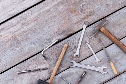 Preview: Different construction tools on wooden background.