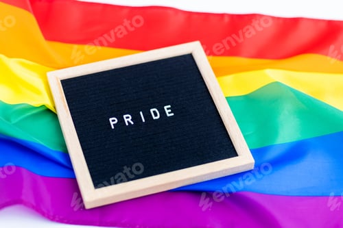 Preview: Frame with inscription pride lying on bright and colorful rainbow flag background