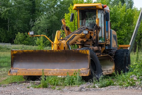 Preview: Old yellow tractor grader. Bashkortostan, Russia - 12 June, 2021.