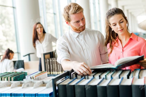 Preview: Two students reading and studying in library