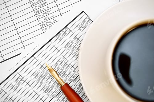 Preview: Coffee and pen on the documents.