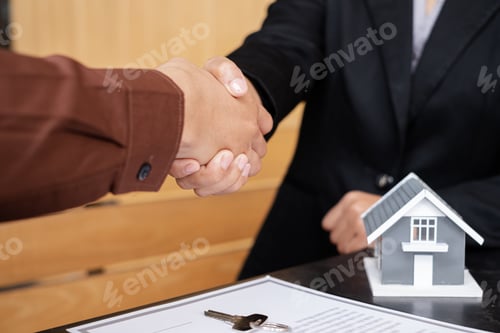 Preview: Businessmen and brokers real estate agents shake hands after completing negotiations to buy houses
